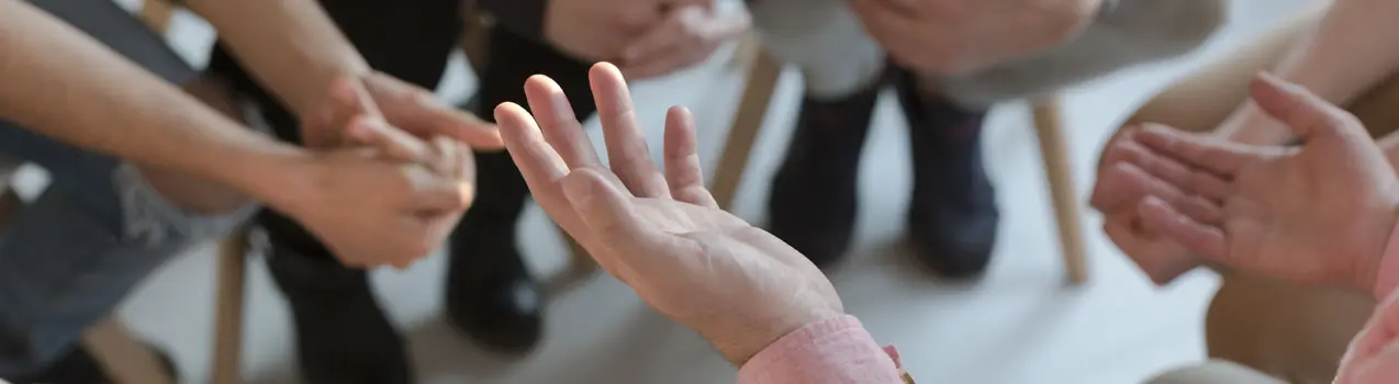 Panorama of therapist's hands while gesticulating during group therapy