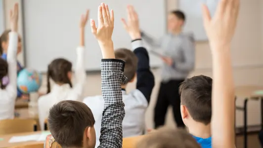 School children in classroom at lesson. Kinder im Klassenraum