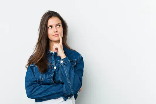 Young cute woman looking sideways with doubtful and skeptical expression. looking sideways with doubtful and skeptical expression.