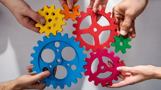 Business team connect pieces of gears. Teamwork, partnership and integration concept Business team connect pieces of gears. Teamwork, partnership and integration concept